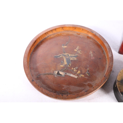 77 - Chinese lacquered hinge top box, 20cm long and a circular tray with gilded relief floral decoration,... 