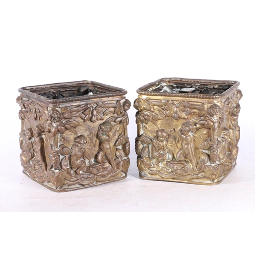 87 - Pair of gilded brass square section plant pots with relief cherub and floral decoration, 12cm high.