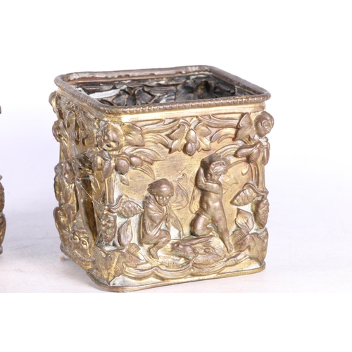 87 - Pair of gilded brass square section plant pots with relief cherub and floral decoration, 12cm high.