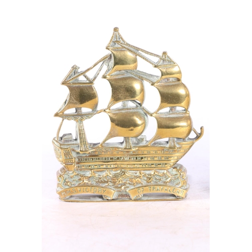 97 - Pair of pierced brass bookends modelled as the ship HMS Victory, 15cm tall.