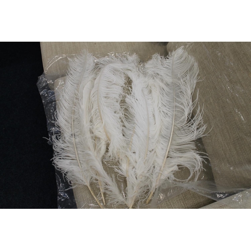 318 - Seven white coloured ostrich feathers.