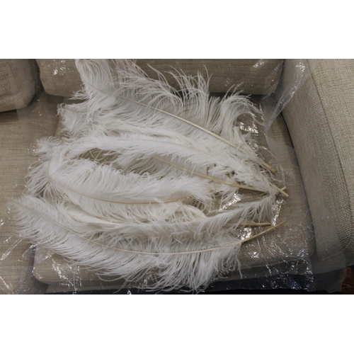 318 - Seven white coloured ostrich feathers.