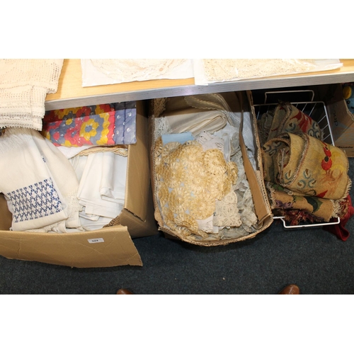 324 - Tapestry embroideries, fringed tassel cuttings and two boxes of fabrics, linens, quilts, etc.