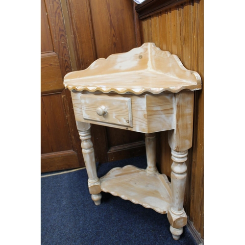 401 - Stripped pine corner unit with ledge back and frieze drawer raised on turned supports, 64cm wide.