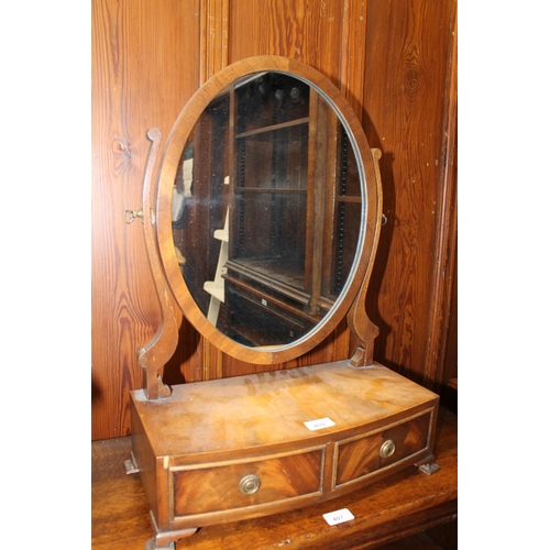 409 - Mahogany swing dressing mirror raised on bowfront platform base upon squat bracket feet, 43cm wide.