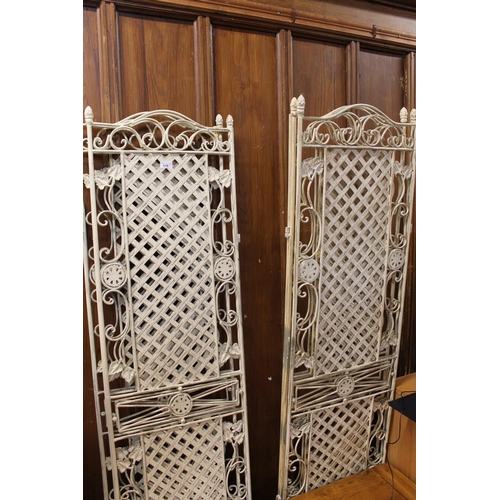 416 - Two cream painted metal folding screens, 180cm tall.