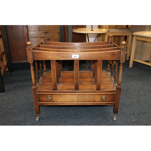 423 - Reproduction mahogany canterbury raised on square supports capped by castors, 56cm wide.