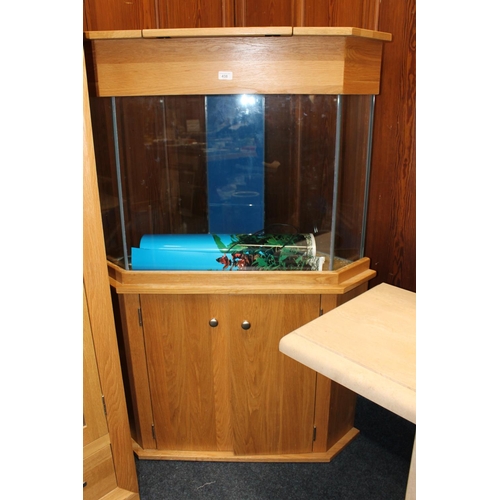 438 - Large corner fish tank on cupboard base, 145cm high x 99cm at widest point.