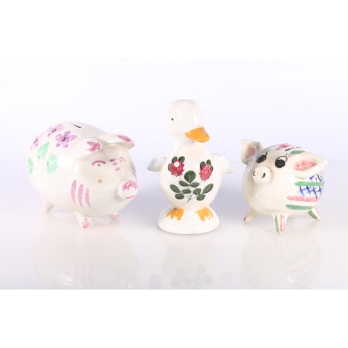 129 - Plichta pottery model of duck and two hand-painted pottery piggy banks.  (2)