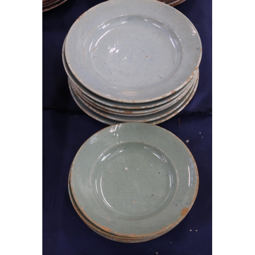 135 - Celadon tin glazed earthenware dishes, 20cm and 17cm diameter.