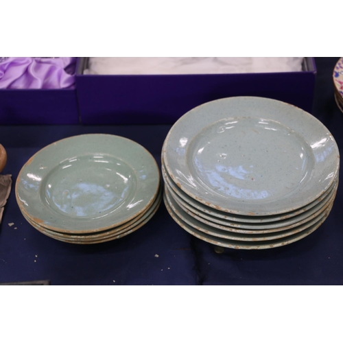 135 - Celadon tin glazed earthenware dishes, 20cm and 17cm diameter.