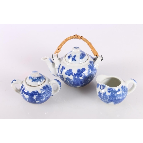 141 - Chinese style miniature blue and white toy china tea service in original box.