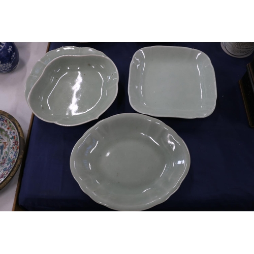 145 - Three oriental celadon dishes, possibly Korean, the largest 26cm wide.