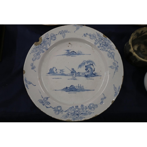 149 - 18th century tin glazed blue and white charger decorated with chinoiserie scene, 30cm diameter, and ... 