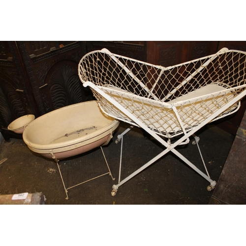 285 - Cream painted metal folding child's cot, and a bath on stand.