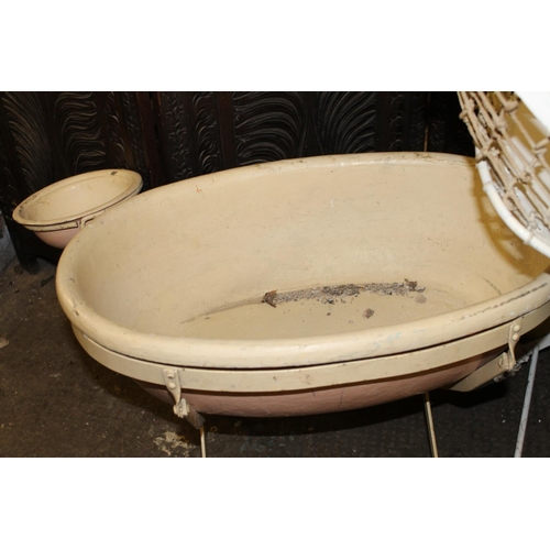 285 - Cream painted metal folding child's cot, and a bath on stand.