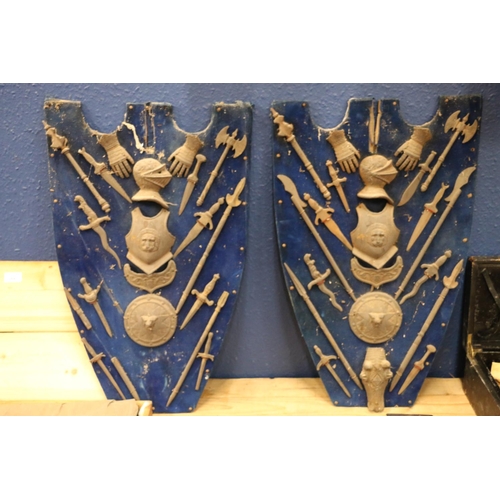 355 - Two blue baize shield plaques decorated with cast metal miniature arms including a suit of armour, g... 