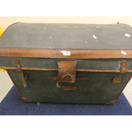 379 - Large doom top canvas and leather whicker travel trunk.