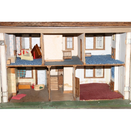 204 - Vintage two storey dolls house, with some fittings and furniture, 78cm long.