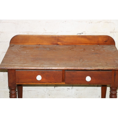 213 - Early 20th century pine side table with two frieze drawers, raised on turned supports, 91cm wide.