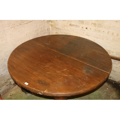 225 - Victorian mahogany extending dining table, raised on turned supports, capped by castors.