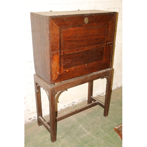 238 - Antique oak campaign cabinet on stand, the fall front with fully fitted interior including drawers, ... 