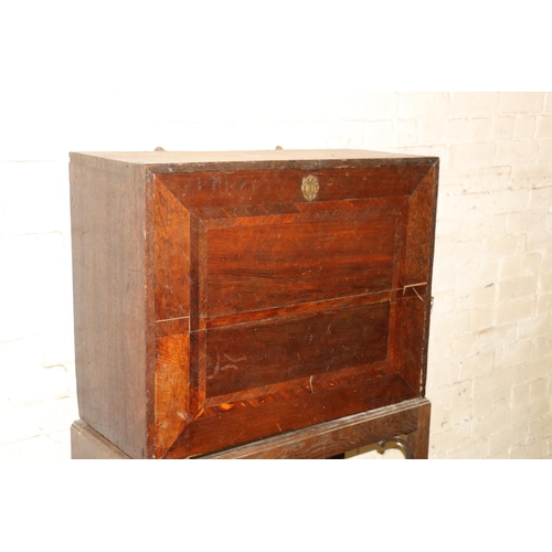 238 - Antique oak campaign cabinet on stand, the fall front with fully fitted interior including drawers, ... 