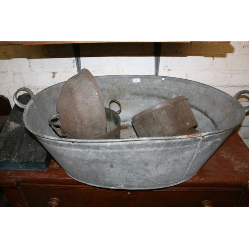 247 - Antique metal twin handled bath and contents.