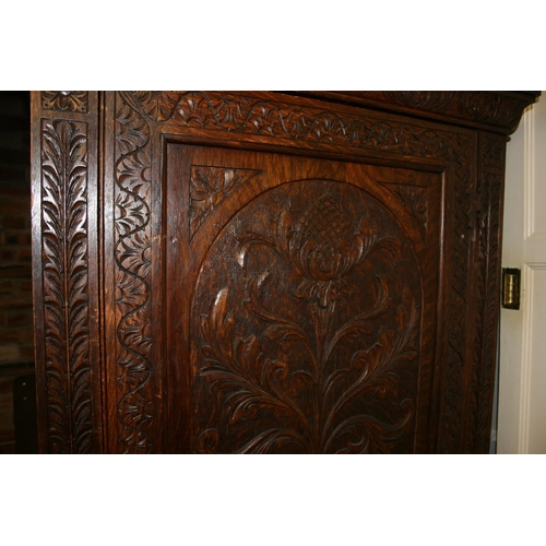 262 - Jacobean revival chip carved oak cupboard with panel door above base drawer, raised on plinth, 87cm ... 