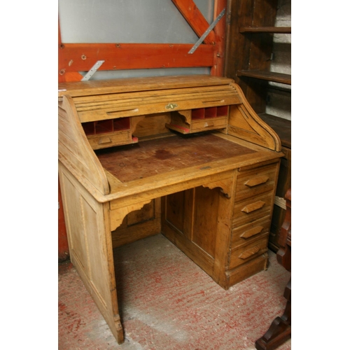 264 - Oak roll top desk with kneehole and pedestal of drawers, the tambour front opening to reveal fitted ... 