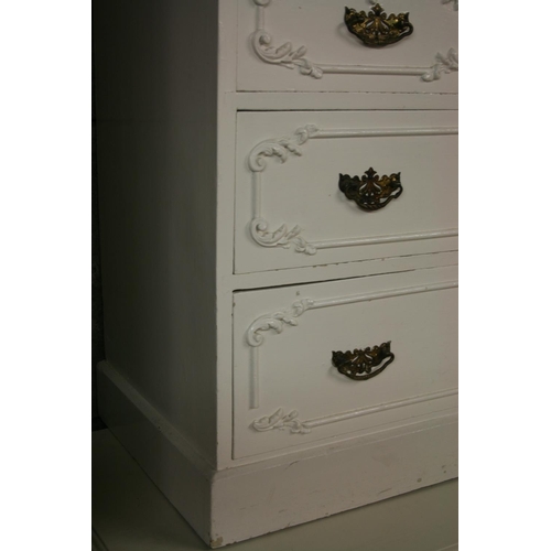 268 - Antique cream painted chest of drawers with applied scrolling foliage sprays, having two short drawe... 