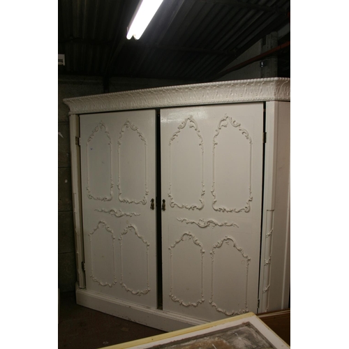 269 - Large French style corner wardrobe, the ornate cornice with acanthus leaf and berry design above two... 