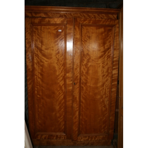 270 - Victorian satin birch two door wardrobe, raised on plinth base, 209cm high.