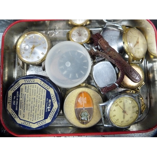 115 - Tin containing assorted manual wind, quartz and automatic watch parts and a Roamer watch box.