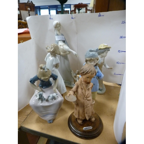 232 - Lladro figure of a girl holding a goose and puppy at her feet, four assorted Nao figures and another... 