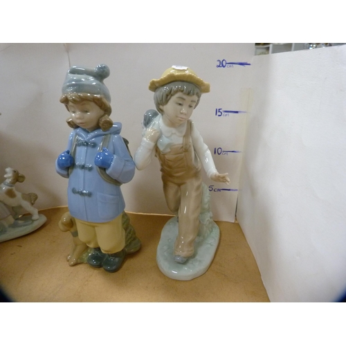 232 - Lladro figure of a girl holding a goose and puppy at her feet, four assorted Nao figures and another... 