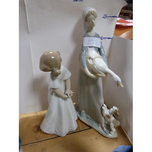 232 - Lladro figure of a girl holding a goose and puppy at her feet, four assorted Nao figures and another... 