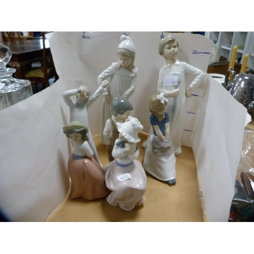 235 - Seven assorted Nao figures to include a pair wearing nightgowns.  (7)