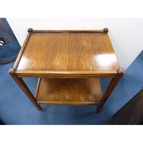 445 - Small mahogany open bookcase with two drawers above and an oak tea trolley.  (2)