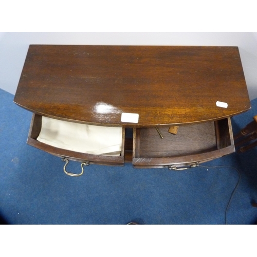 445 - Small mahogany open bookcase with two drawers above and an oak tea trolley.  (2)