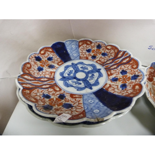 68 - Four Meiji period Japanese Imari dishes and a Japanese blue and white dish with frilly rim.  (5... 