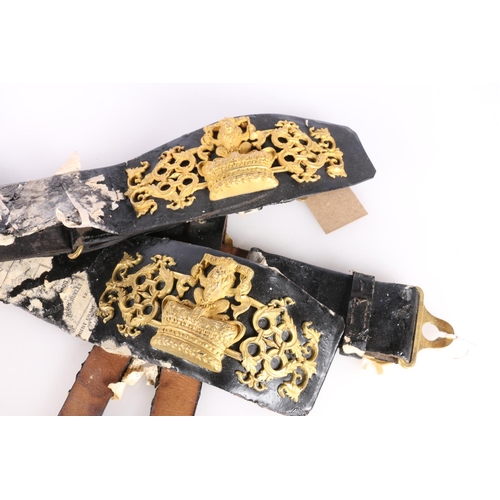 394 - Two black leather belts with Ich Dien, lion and crown insignia. (2)