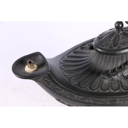 43 - Wedgwood black basalt oil lamp in the form of an Aladdin lamp with figure reading surmount, 23cm tal... 