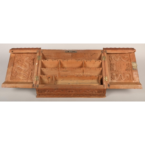 510 - Hardwood letter rack with dragon and Oriental designs in relief 