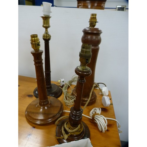 251 - Four wooden table lamps.