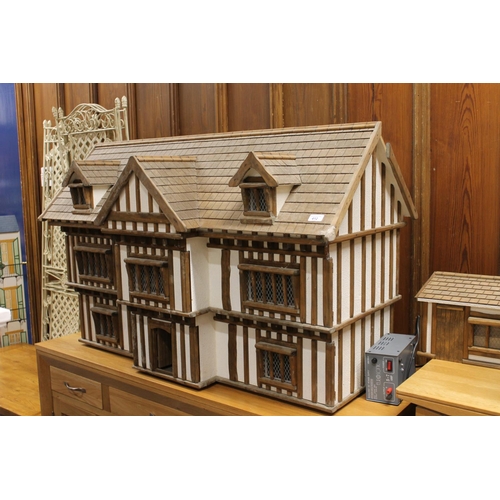 412 - Large mock Tudor style dolls house with accessories, 122cm long.