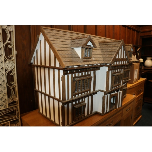 412 - Large mock Tudor style dolls house with accessories, 122cm long.