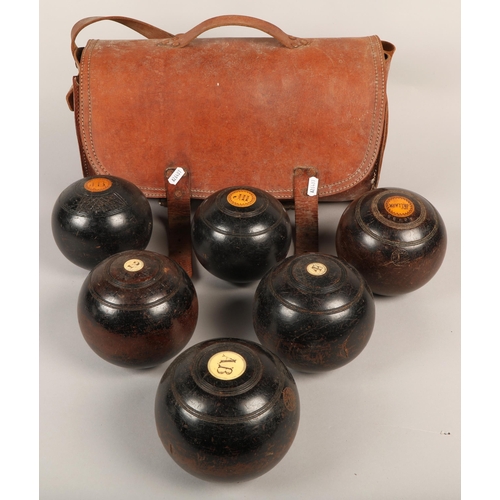 349 - Six lawn bowls in leather case with bowls related book