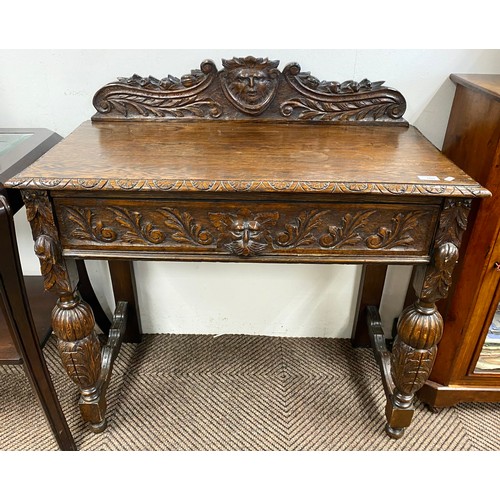 505 - Ornate oak hall table with floral and classical design in relief with fitted drawer