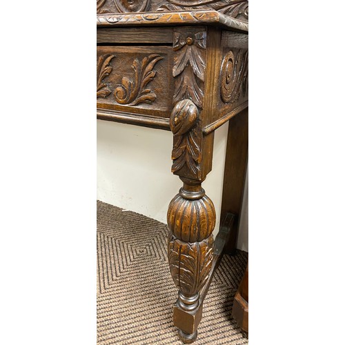 505 - Ornate oak hall table with floral and classical design in relief with fitted drawer